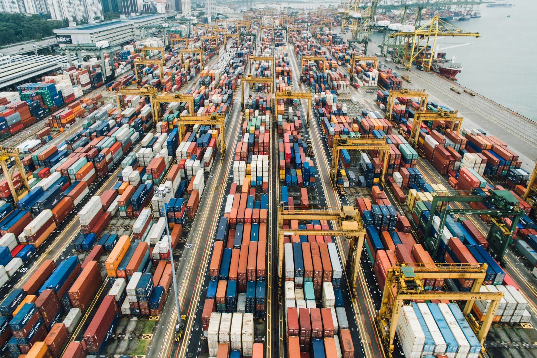 Aerial view of a container yard and port cranes